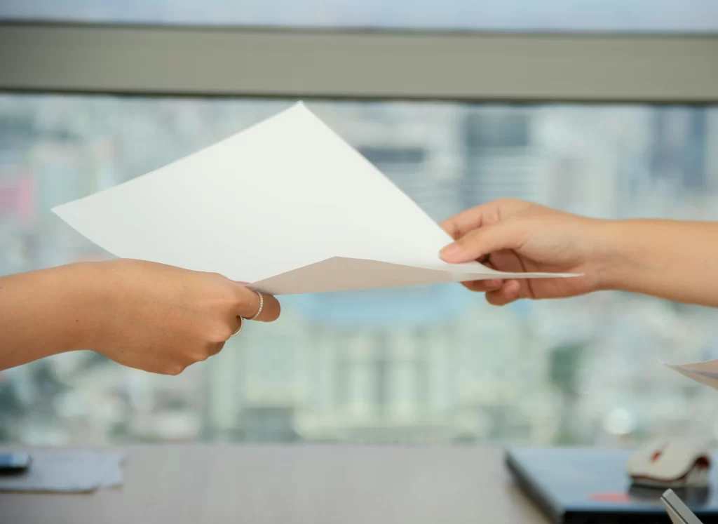 Paper, hands, delegate, outsource, business deal